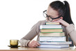 Student sleeping over books at the table