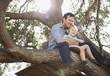 Father and son hugging in tree