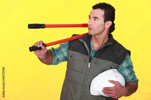 Photo: Man resting bolt-cutters on his shoulder Man resting bolt-cutters on his shoulder