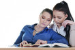 Two students tired of books at the table
