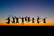 silhouette of friends jumping in sunset silhouette of friends jumping in sunset