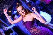 Young woman having fun at nightclub disco