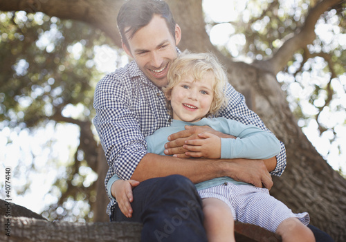 Photo: Father and son relaxing outdoors Father and son relaxing outdoors