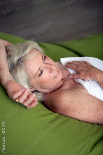 Photo: Old lady relaxing on the terrace Old lady relaxing on the terrace