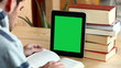 Boy studying with tablet (with green screen)