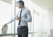 Businessman standing at window in office