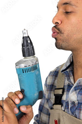 Photo: man in profile with drill man in profile with drill