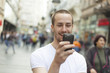 Young Man with cell phone walking