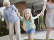 Three generations of women holding hands