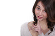 Young woman holding her index finger up to her lips
