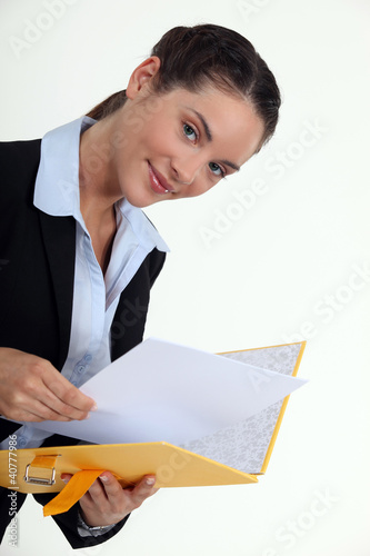 Photo: Woman holding yellow folder Woman holding yellow folder