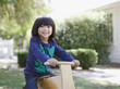 Boy riding toy bicycle outdoors