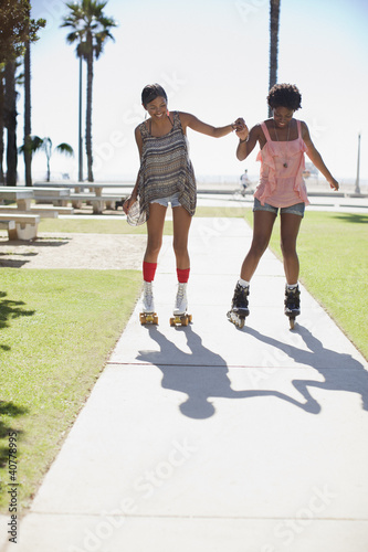 Photo: Women skating together outdoors Women skating together outdoors
