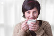 Woman drinking hot beverage