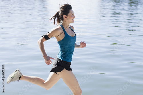 Photo: Woman running along lake Woman running along lake