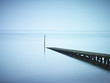Pier jutting out into still lake