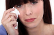 Woman crying with a tissue Woman crying with a tissue