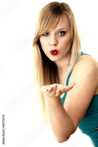 Photo: beautiful young woman blowing a kiss beautiful young woman blowing a kiss
