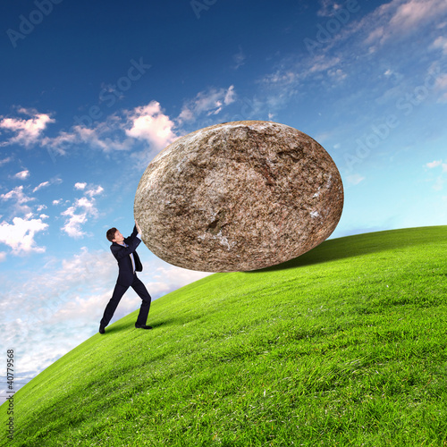 Illustration: Businessman rolling a giant stone Businessman rolling a giant stone