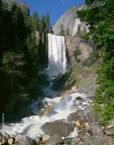 Photo: Waterfall pouring over rocky cliff Waterfall pouring over rocky cliff