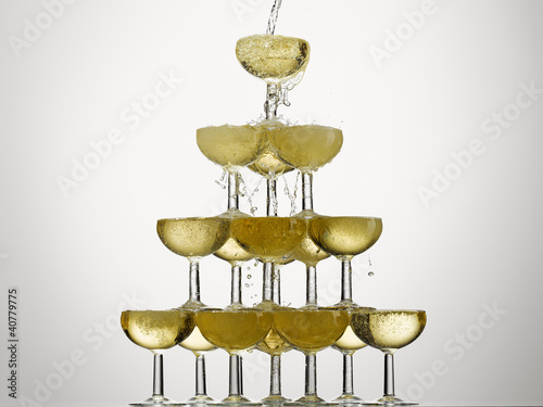 Photo: Champagne pouring into stacked glasses Champagne pouring into stacked glasses