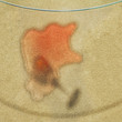 Spill on glass table reflected into carpet