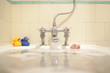 Faucet pouring water into bath tub