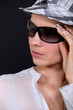 portrait of young woman with sunglasses and cap