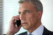 mature businessman talking on his cell