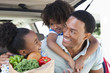 Family unloading groceries from car