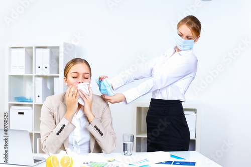 Photo: People with cold and flu at work place People with cold and flu at work place