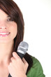 Young brunette holding micro[hone Young brunette holding micro[hone
