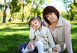 Grandmother with her little granddaghter in park