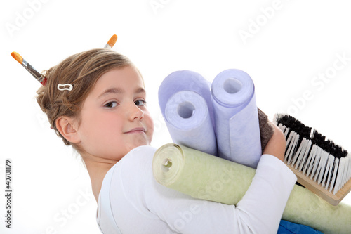 Photo: A little girl with wallpaper rolls. A little girl with wallpaper rolls.