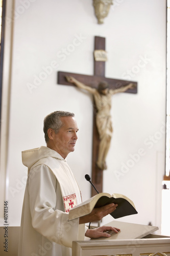 Photo: Priest giving sermon in church Priest giving sermon in church