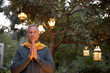 Older man praying in backyard