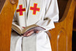 Close up of priest reading Bible
