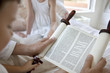 Family reading Torah scrolls together