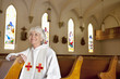 Reverend sitting in church pews