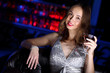Young woman in night club with a drink
