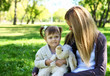 Little girl playing with mother in summer park