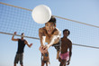 Photo: Man diving for volleyball on beach Man diving for volleyball on beach