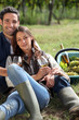 Couple with a glass of wine and basket of grapes