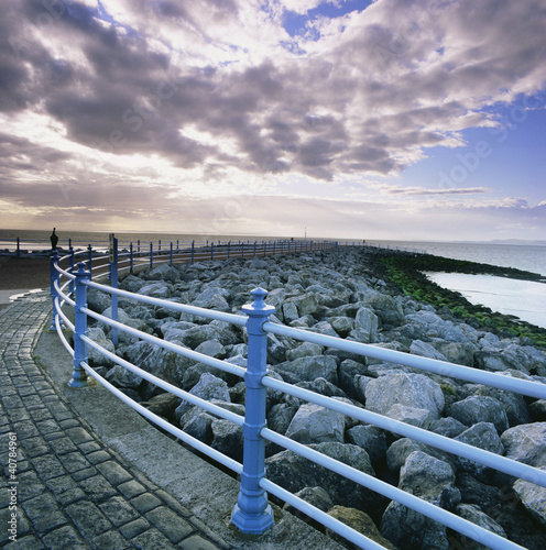 Photo: Railing along stone walkway near beach Railing along stone walkway near beach