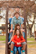 Happy teenage boys and girls spending time together in the park