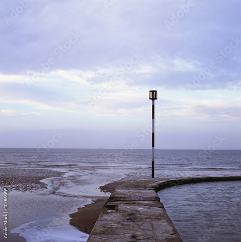 Photo: Waves washing up on stone pier Waves washing up on stone pier