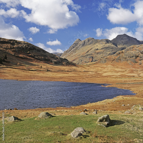 Photo: Lake and rocky mountains in rural landscape Lake and rocky mountains in rural landscape