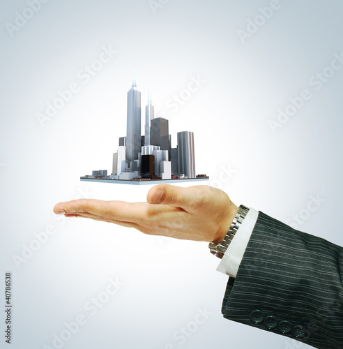 Photo: Business city center in businessman's hand Business city center in businessman's hand