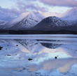 Still lake and mountains in arctic landscape