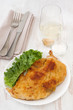 fried turkey with salad on the white plate